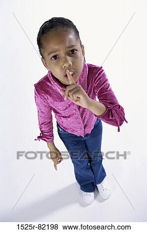 Portrait of a girl with her finger on her lips View Large Photo Image Stock Photo - Portrait of a girl with her finger on her lips. Fotosearch