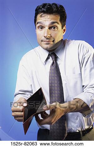 Portrait of a man holding an empty wallet View Large Photo Image Stock Image - Portrait of a man holding an empty wallet. Fotosearch