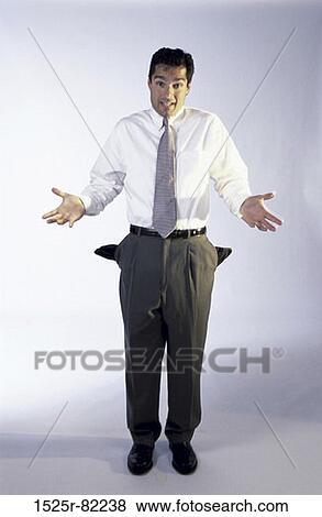 Stock Photo - Portrait of a man standing with his pockets turned inside out. Fotosearch
