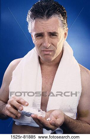 Portrait of a man taking pills from a bottle View Large Photo Image Stock Photography - Portrait of a man taking pills from a bottle. Fotosearch