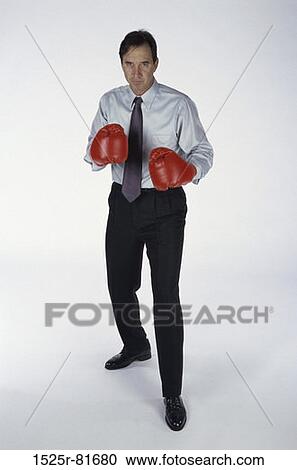 Stock Image - Portrait of a man wearing boxing gloves. Fotosearch
