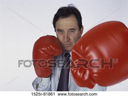Portrait of a man wearing boxing gloves View Large Photo Image Stock Image - Portrait of a man wearing boxing gloves. Fotosearch