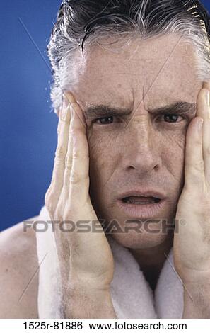 Portrait of a mid adult man holding his head in pain View Large Photo Image Stock Photograph - Portrait of a mid adult man holding his head in pain. Fotosearch
