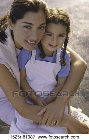 Portrait of a mother holding her daughter View Large Photo Image Stock Photo - Portrait of a mother holding her daughter. Fotosearch