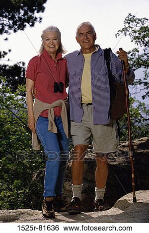 Portrait of a senior couple standing on a rock View Large Photo Image Stock Photograph - Portrait of a senior couple standing on a rock. Fotosearch