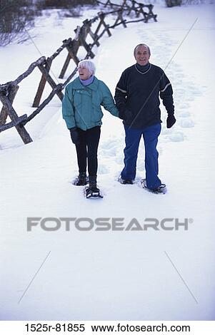 Portrait of a senior couple walking on snow View Large Photo Image Stock Photography - Portrait of a senior couple walking on snow. Fotosearch