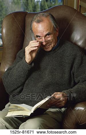 Stock Image - Portrait of a senior man holding a book. Fotosearch
