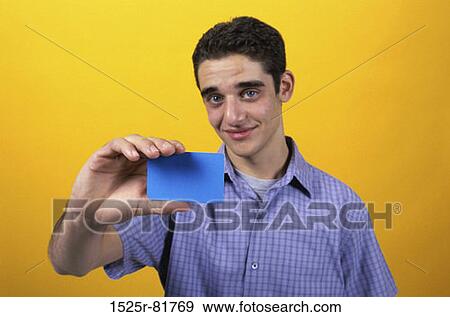 Portrait of a teenage boy holding a card View Large Photo Image Stock Photo - Portrait of a teenage boy holding a card. Fotosearch