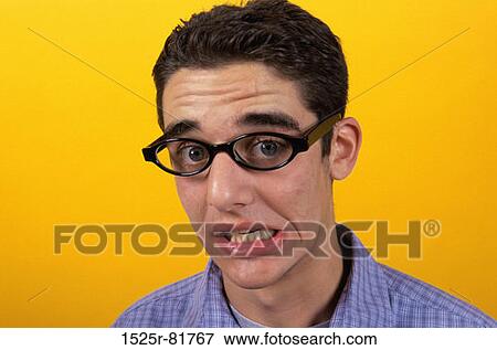 Portrait of a teenage boy making a face View Large Photo Image Stock Photo - Portrait of a teenage boy making a face. Fotosearch