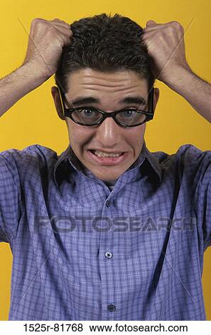 Stock Photo - Portrait of a teenage boy with his hands on his head. Fotosearch