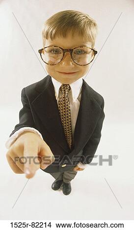 Portrait of a young boy dressed as a businessman pointing View Large Photo Image Picture - Portrait of a young boy dressed as a businessman pointing. Fotosearch
