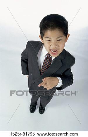 Portrait of a young boy dressed as a businessman pointing View Large Photo Image Stock Photography - Portrait of a young boy dressed as a businessman pointing. Fotosearch