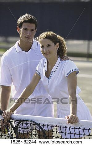 Portrait of a young couple on a tennis court View Large Photo Image Picture - Portrait of a young couple on a tennis court. Fotosearch