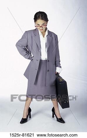 Portrait of a young girl dressed as a businesswoman holding a briefcase View Large Photo Image Stock Image - Portrait of a young girl dressed as a businesswoman holding a briefcase. Fotosearch