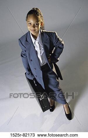 Portrait of a young girl dressed as a businesswoman View Large Photo Image Stock Image - Portrait of a young girl dressed as a businesswoman. Fotosearch