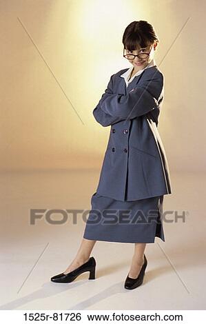 Stock Photograph - Portrait of a young girl dressed as a businesswoman smiling. Fotosearch