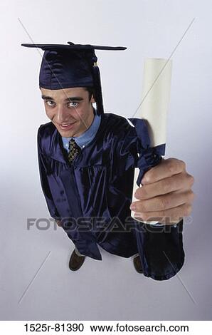 Portrait of a young male graduate holding a diploma View Large Photo Image Stock Image - Portrait of a young male graduate holding a diploma. Fotosearch