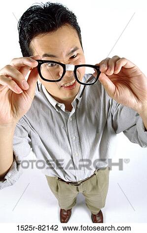Portrait of a young man holding a pair of eyeglass View Large Photo Image Stock Image - Portrait of a young man holding a pair of eyeglass. Fotosearch