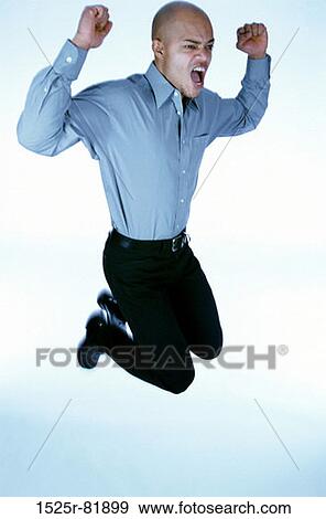 Stock Photo - Portrait of a young man jumping in mid-air. Fotosearch