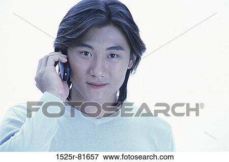 Portrait of a young man talking on a mobile phone View Large Photo Image Stock Photo - Portrait of a young man talking on a mobile phone. Fotosearch