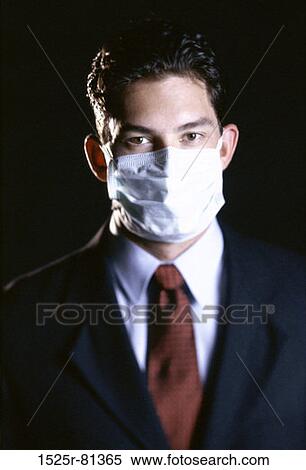 Portrait of a young man wearing a surgical mask View Large Photo Image Stock Photography - Portrait of a young man wearing a surgical mask. Fotosearch
