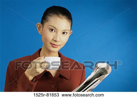 Portrait of a young woman holding a teacup View Large Photo Image Stock Image - Portrait of a young woman holding a teacup. Fotosearch