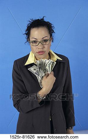 Portrait of a young woman holding paper money View Large Photo Image Stock Photograph - Portrait of a young woman holding paper money. Fotosearch