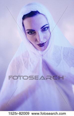 Stock Photo - Portrait of a young woman with cloth over her head. Fotosearch