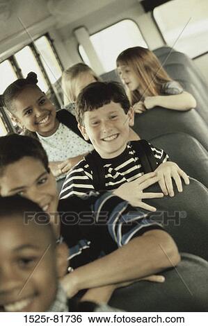 Portrait of school children sitting in a school bus View Large Photo Image Stock Photograph - Portrait of school children sitting in a school bus. Fotosearch