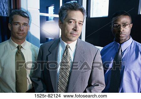 Portrait of three businessmen standing in an office View Large Photo Image Picture - Portrait of three businessmen standing in an office. Fotosearch
