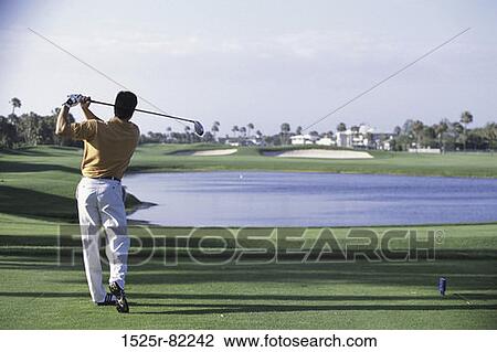 Rear view of a man playing golf View Large Photo Image Stock Image - Rear view of a man playing golf. Fotosearch