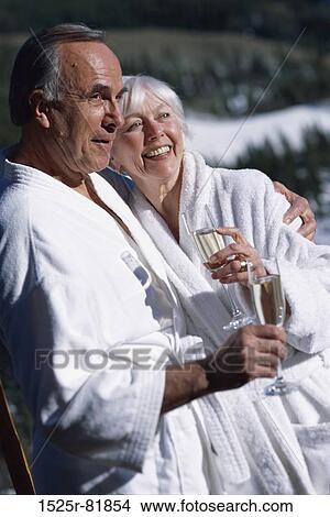Senior couple holding glasses of champagne View Large Photo Image Picture - Senior couple holding glasses of champagne. Fotosearch