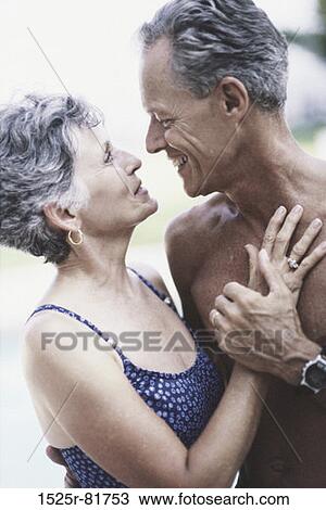 Stock Image - Senior couple hugging each other. Fotosearch