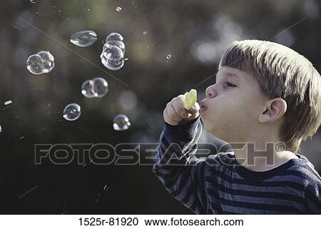 Side profile of a boy blowing bubbles View Large Photo Image Stock Image - Side profile of a boy blowing bubbles. Fotosearch