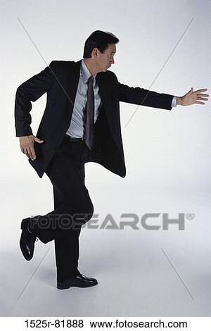 Stock Photo - Side profile of a businessman dancing. Fotosearch