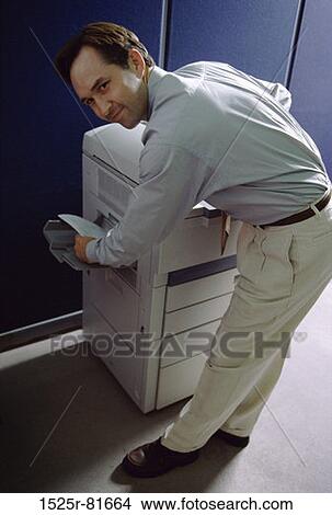 Side profile of a businessman using a photocopier machine View Large Photo Image Picture - Side profile of a businessman using a photocopier machine. Fotosearch
