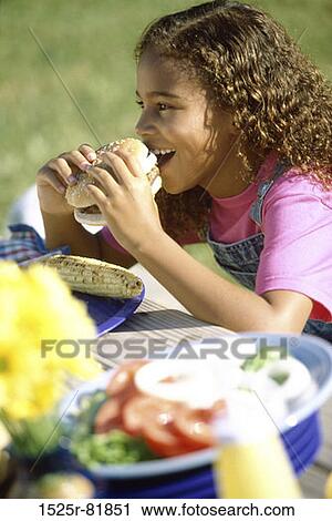 Side profile of a girl eating a hamburger View Large Photo Image Stock Image - Side profile of a girl eating a hamburger. Fotosearch