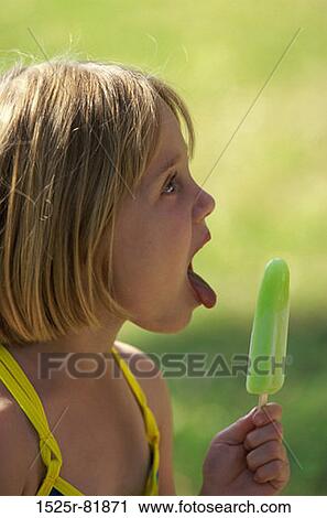Side profile of a girl holding an ice cream View Large Photo Image Stock Image - Side profile of a girl holding an ice cream. Fotosearch
