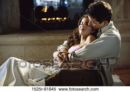 Side profile of a young couple holding each other View Large Photo Image Stock Photography - Side profile of a young couple holding each other. Fotosearch