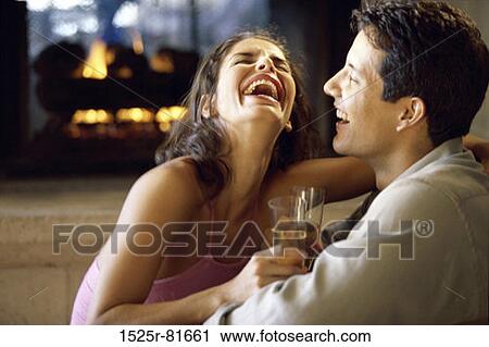 Side profile of a young couple laughing View Large Photo Image Stock Image - Side profile of a young couple laughing. Fotosearch