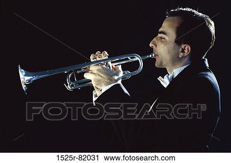 Side profile of a young man playing the trumpet View Large Photo Image Stock Image - Side profile of a young man playing the trumpet. Fotosearch
