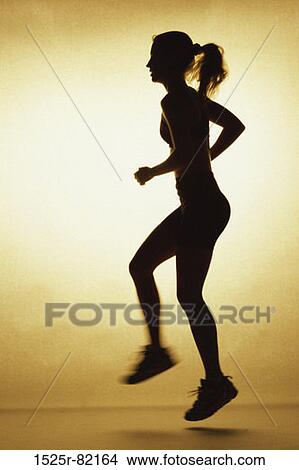 Silhouette of a young woman exercising View Large Photo Image Picture - Silhouette of a young woman exercising. Fotosearch