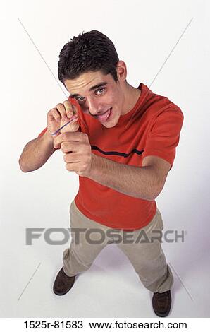 Stock Image - Teenage boy playing with a rubber band. Fotosearch