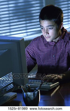 Teenage boy sitting in front of a computer monitor View Large Photo Image Stock Photo - Teenage boy sitting in front of a computer monitor. Fotosearch