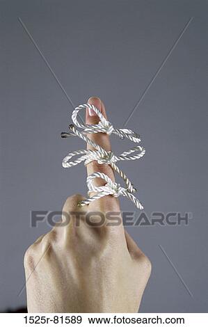 Stock Photo - Three bows tied to a person's finger. Fotosearch