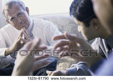 Three businessmen talking in an office View Large Photo Image Stock Image - Three businessmen talking in an office. Fotosearch