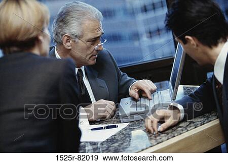 Three businessmen talking in an office View Large Photo Image Stock Photo - Three businessmen talking in an office. Fotosearch