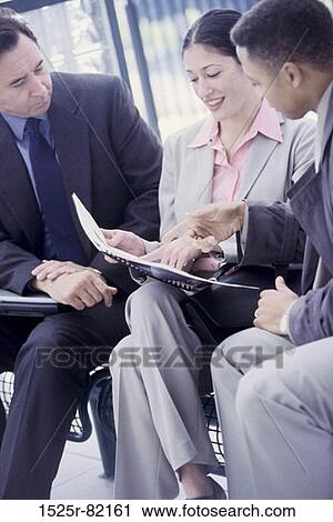 Two businessmen and a businesswoman talking View Large Photo Image Stock Image - Two businessmen and a businesswoman talking. Fotosearch
