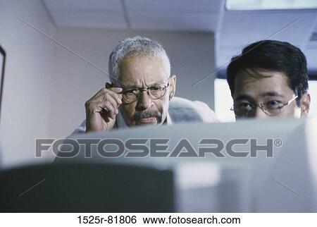 Two businessmen in an office View Large Photo Image Stock Photograph - Two businessmen in an office. Fotosearch