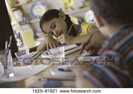 Stock Image - Two children painting with paintbrushes. Fotosearch